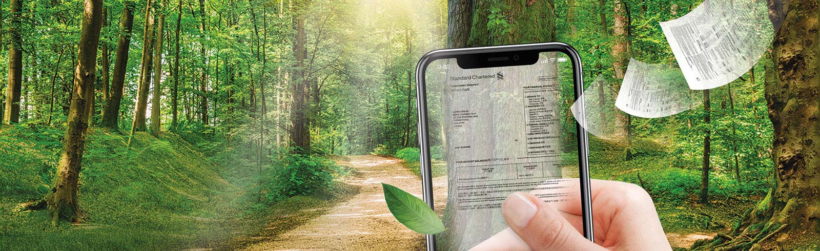 a transparent mobile phone with an e-statement on it, a hand holding it in the wood