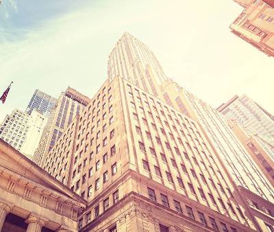 Vintage toned Wall Street at sunset, Manhattan, New York City, USA.