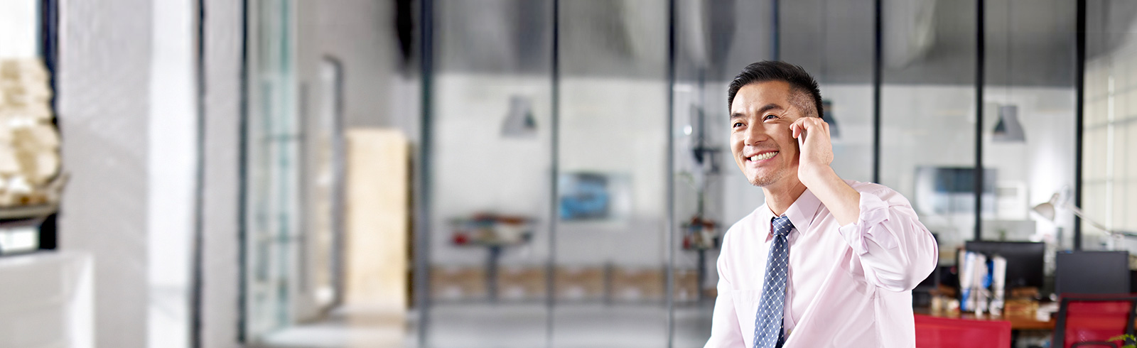 a businessman smiling during phone call, discussing SC business mortgages benefits