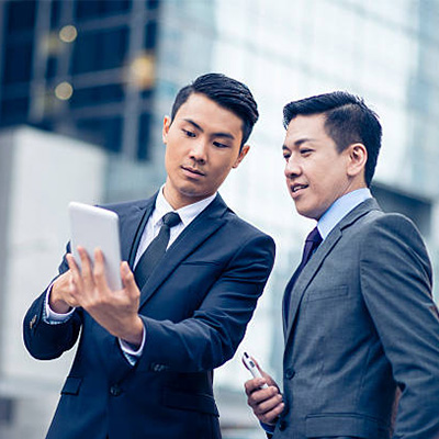 2 businessmen discussing SC's employee banking services on the tablet