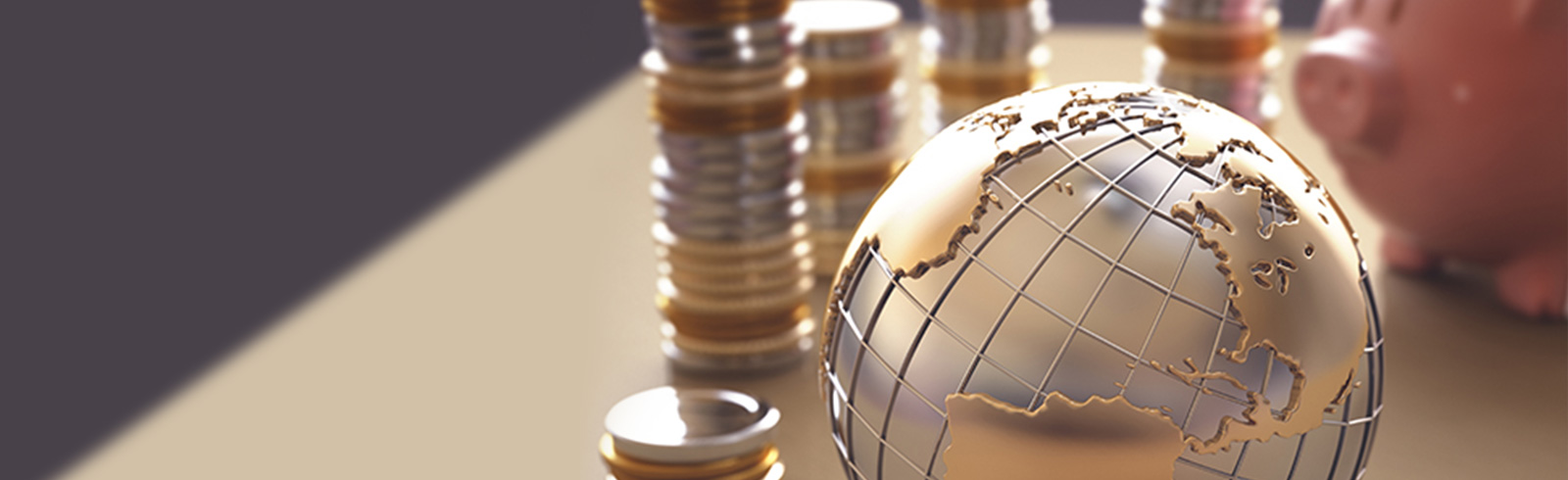 a golden globe with stacks of coins and piggy bank