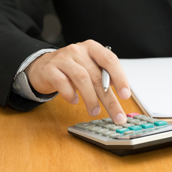 A businessman using a calculator