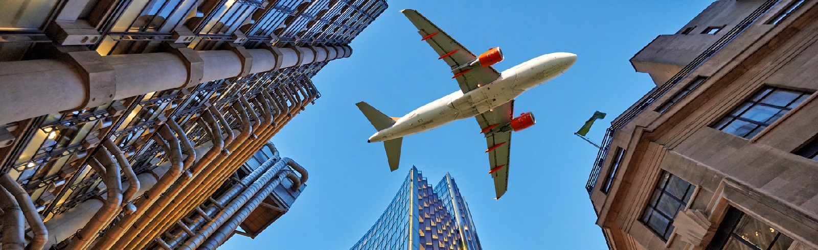 Px photo id a jet plane flying low over three different kind of architecture with commercial office buildings exterior evening view at bottom skyscrapers