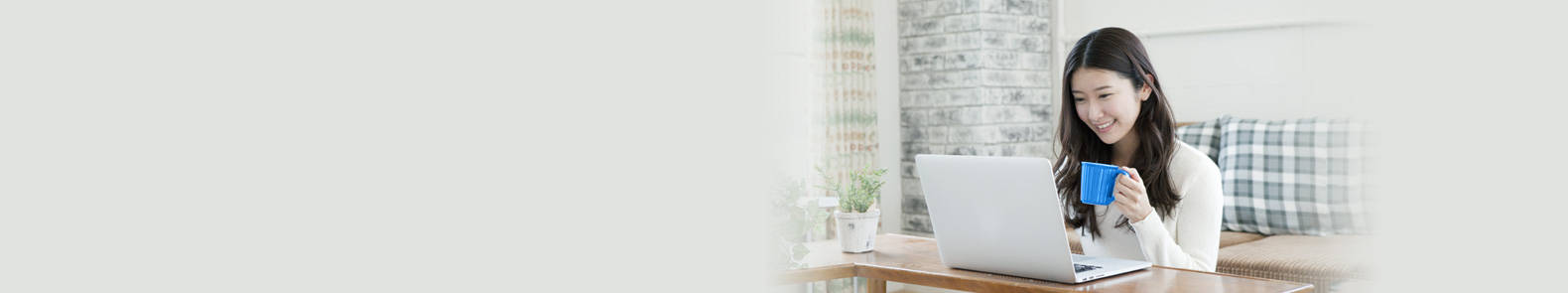 a lady drinking while enjoying online investment benefits with her laptop