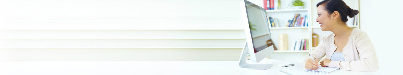 A female looking at her desktop screen