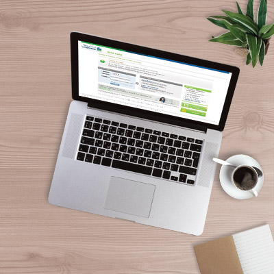 man thinking deep at workdesk with laptop and paper with different charts