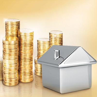 a silver house model and stacks of golden coins at the back