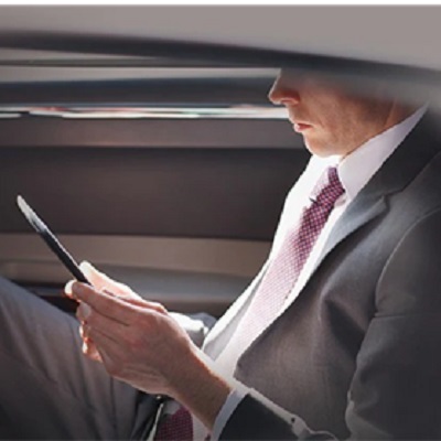 Man in suit invests by phone in car