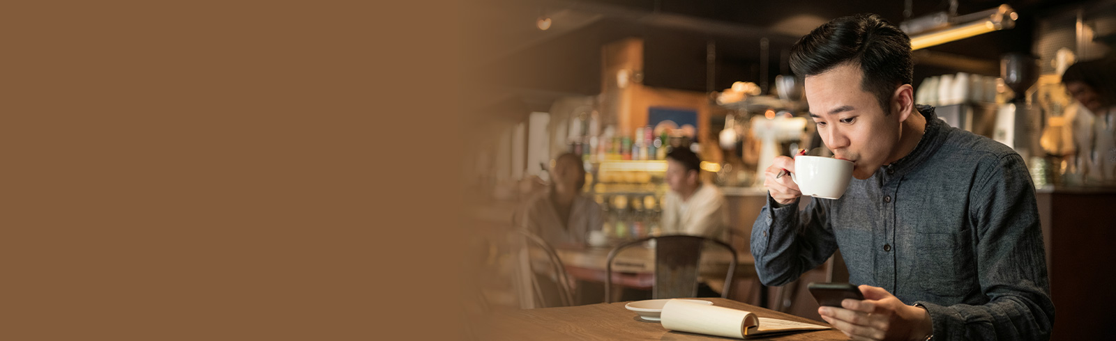 A man is drinking coffee in a cafe