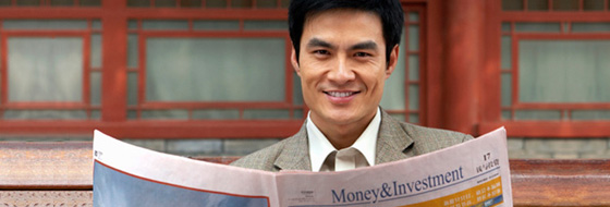 man holding a news paper printed with Money&Investment