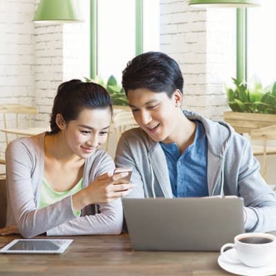A man and a woman are looking on a mobile and discussing