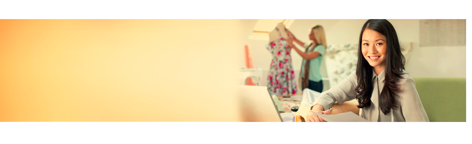 Business lady is looking at camera and smiling while working in office
